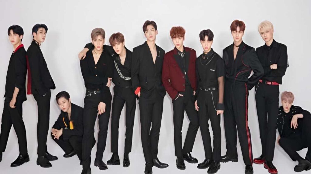 Several men seated at a table, enjoying a pink cake, during the X1 Members Profile gathering.
