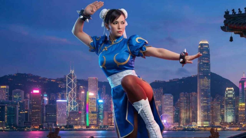 Chun-Li in a karate uniform strikes a pose against a city skyline backdrop