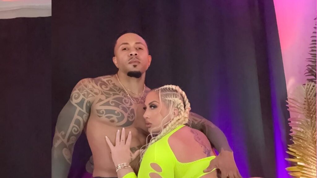 Eddie Jaye wearing matching neon green outfits stand, smiling against a bright background