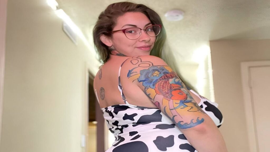 Jessie Minx with intricate tattoos adorning her arms and legs, showcasing her unique style and personal expression