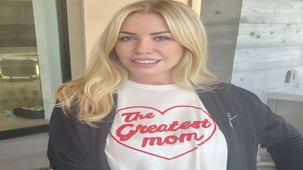 Shannon Tweed proudly wearing a shirt that reads "The Greatest Mom," smiling and showcasing her love for motherhood