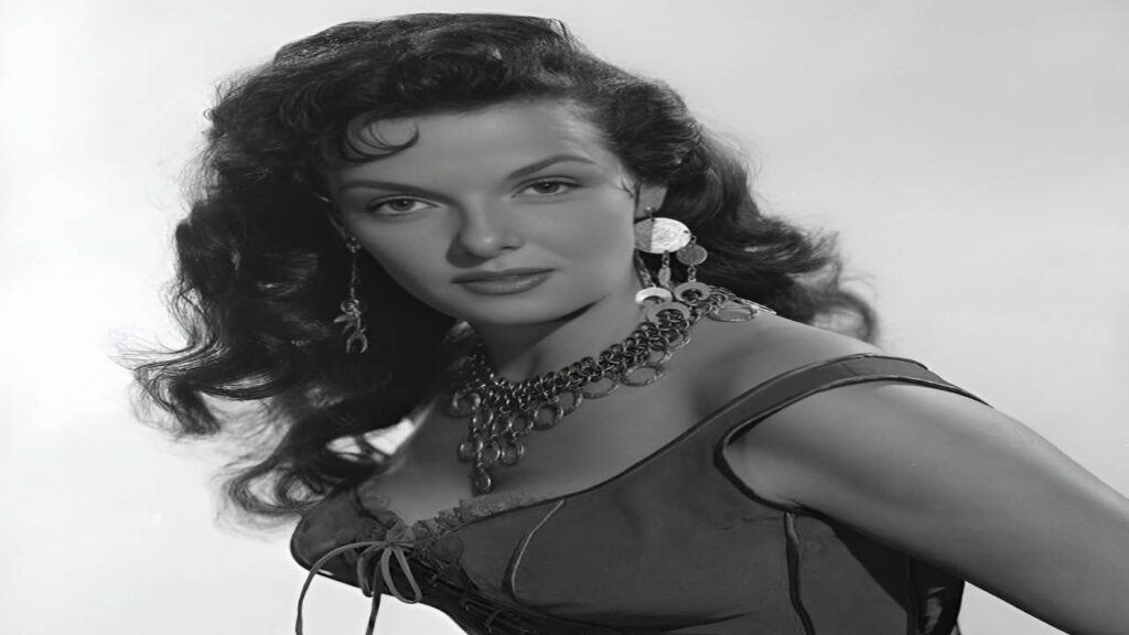 Jane Russell wearing a stylish dress, adorned with elegant earrings and a matching necklace.