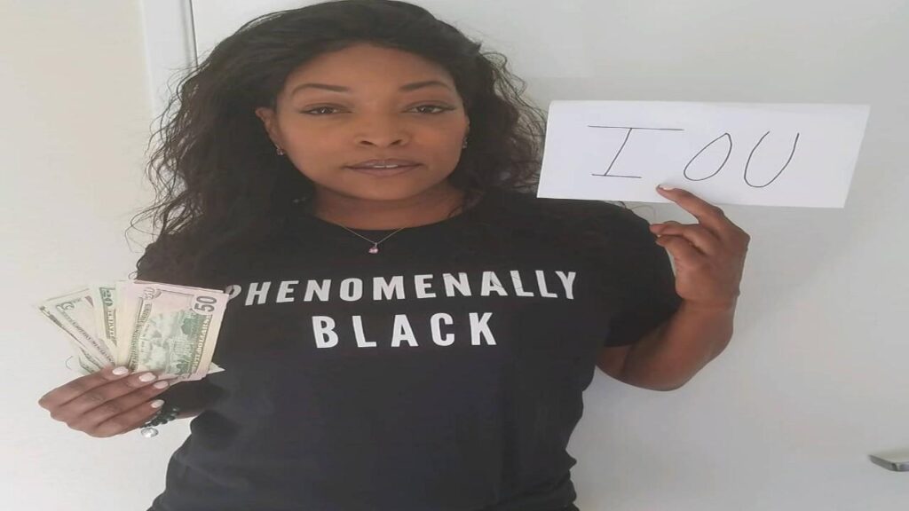 Kellita Smith holds a sign reading "I am normally black," expressing a personal statement on identity and race