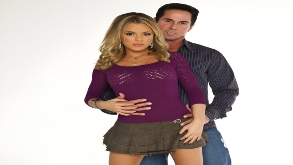 Peter North smiling for a photo, the man wearing a purple shirt