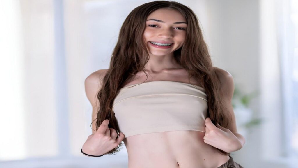 Tiana Blow wearing a crop top and leggings stands confidently, showcasing a casual and stylish athletic look