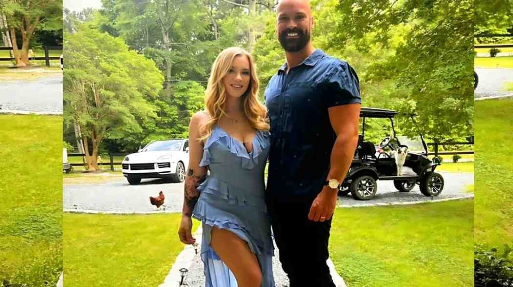 Sean Lawless in a navy shirt, with a golf cart and dog behind.