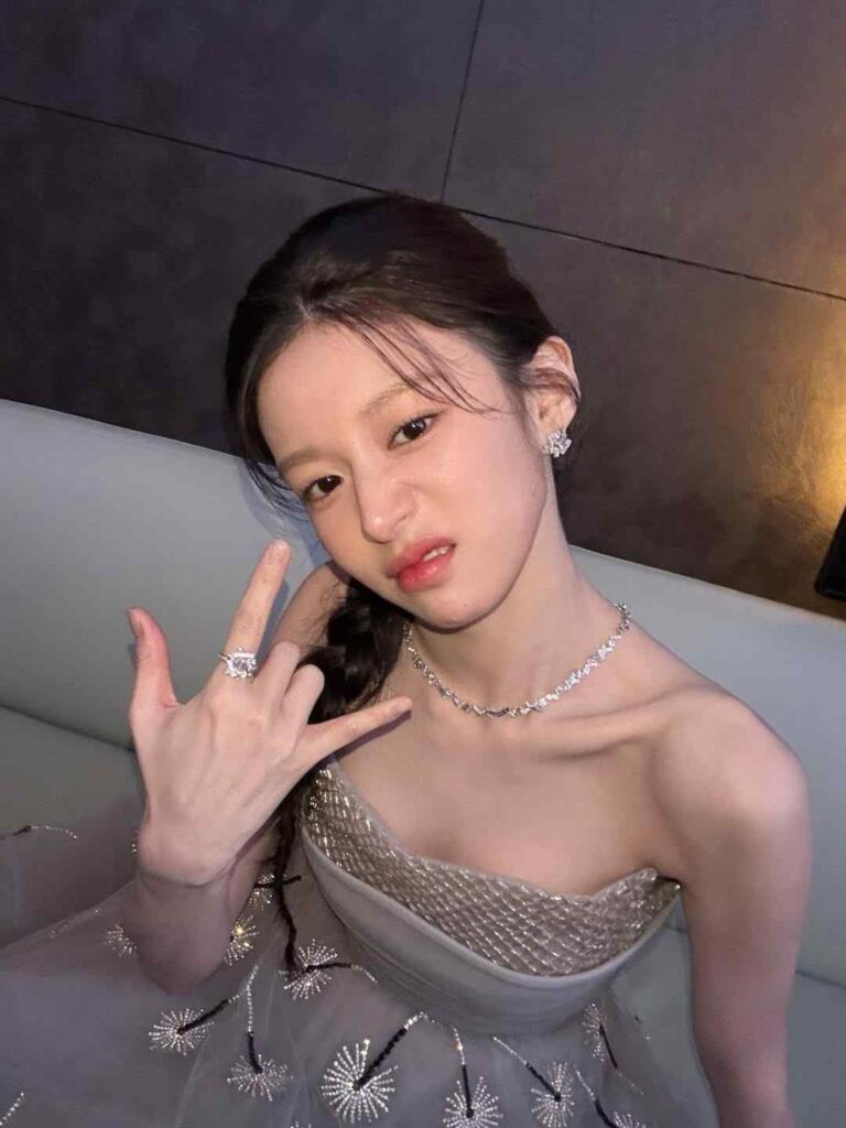 go hyun-jung young in a silver strapless gown with a diamond necklace and earrings, braided hair, making a rock-on gesture.
