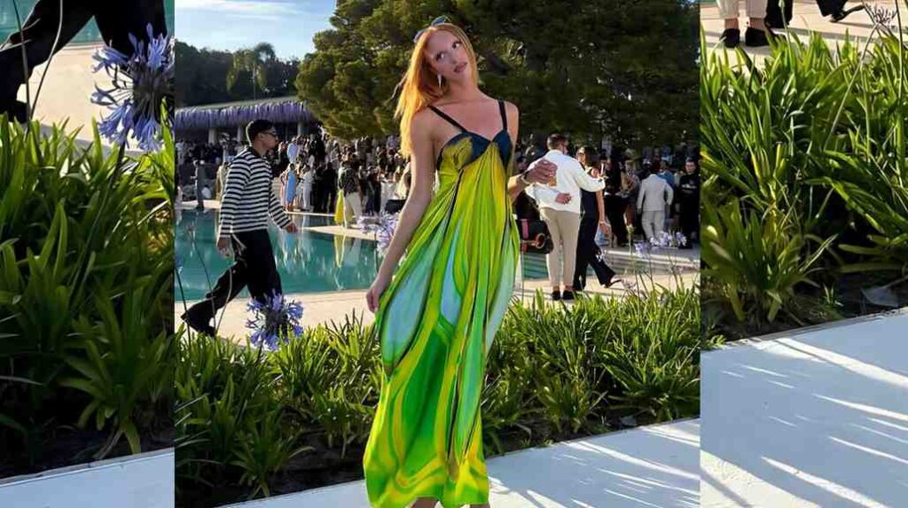 Anna Ermakova in flowing lime-green dress with black straps poses by a pool, lush plants around, guests mingling in background.