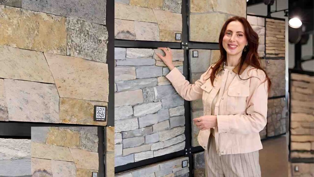 Eva Amurri wall display with stacked panels as a smiling woman touches the stone panels in a showroom.