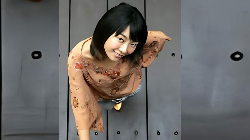 Jung Yoon-jo with short black hair, wearing torn peach blouse and jeans, leaning toward the camera.
