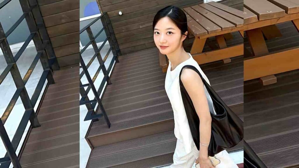Kim Hyun-soo (김현수) stands on a wooden deck, wearing casual attire, with a serene expression and a natural background.