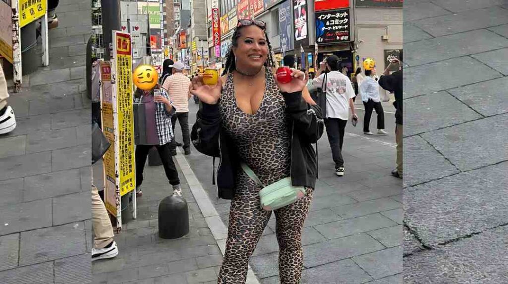 Nyla Rose in a leopard-print jumpsuit and black jacket poses on a busy city street, holding yellow and red items.