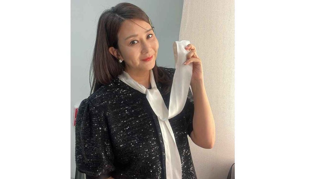 Yang Jung-ah (양정아) with dark hair in a sequined black jacket and white blouse holds a white scarf near her neck in a lit room.