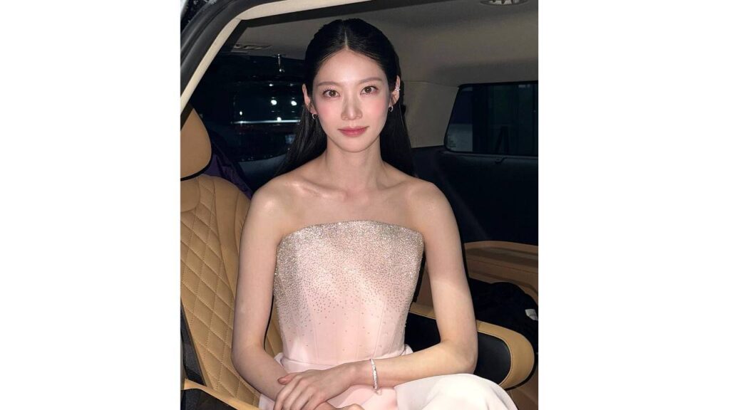 Yeon Ji-seung (연지승) with long dark hair in a strapless pink gown sits in the backseat of a car with tan quilted leather, hands folded.