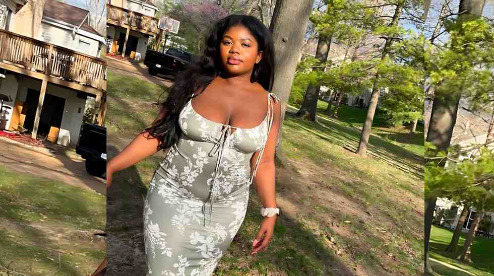 Aaliyah Brown with long black hair poses in a sunlit park, wearing a light gray floral dress with front ties and a white watch, smiling near trees.