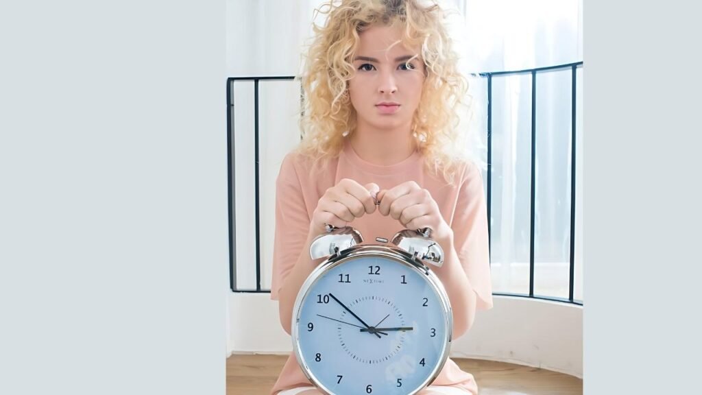 Kia Ahe covers her face with a clock, highlighting the time while creating a sense of mystery.