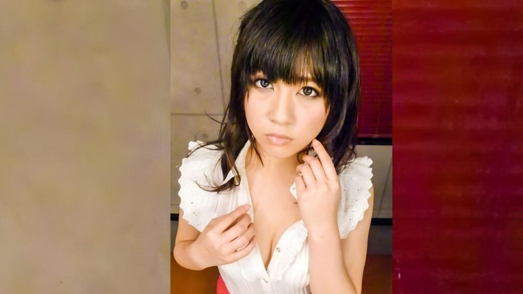 Kyoka Sono (園杏花) with dark bangs and shoulder-length hair gazes at the camera, touching her face in a white blouse.