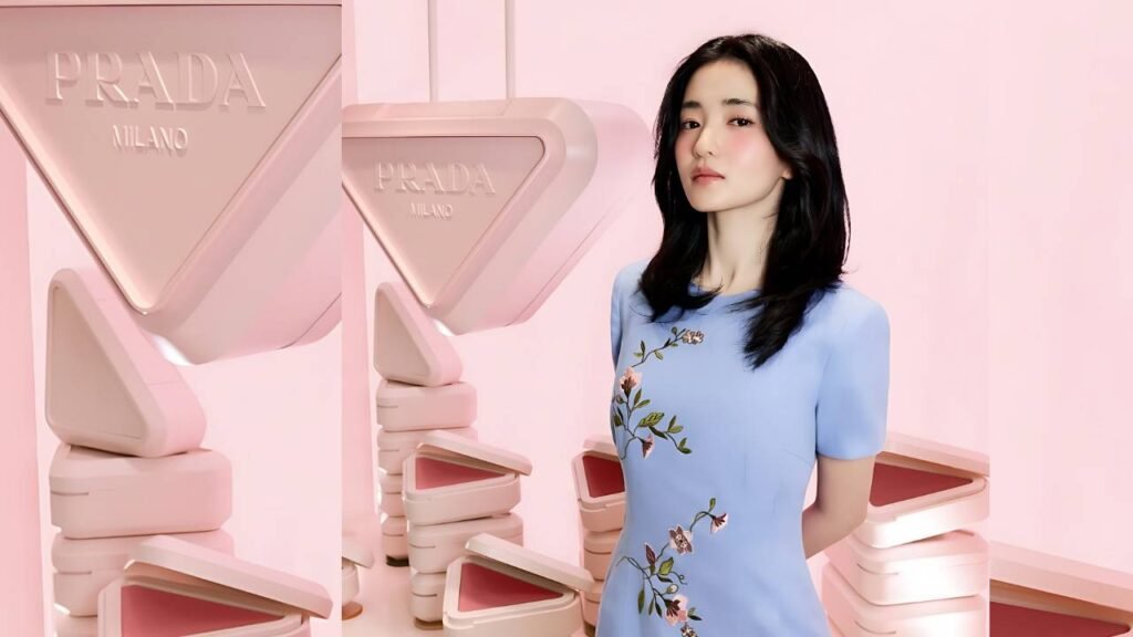 Kim Tae-ri in a light blue floral dress stands beside oversized pink Prada Milano sculptures in a pink room.