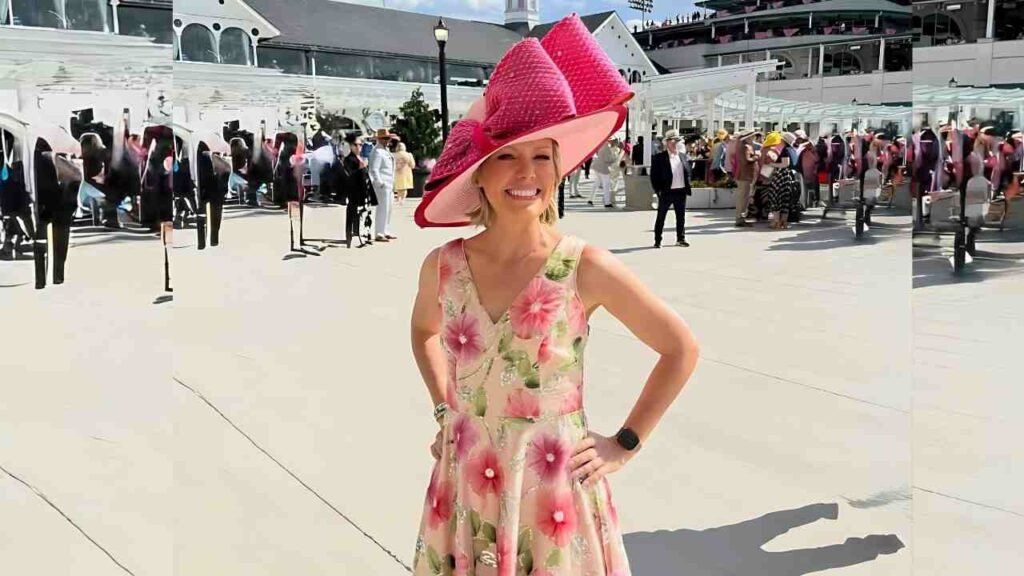 Dylan Dreyer wearing a floral dress and hat poses for a photo, smiling against a blurred outdoor background.