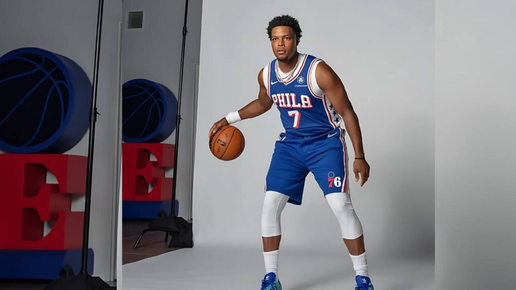 Kyle Lowry wearing a blue jersey is holding a basketball, preparing to make a play on the court.