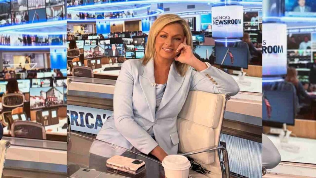 Sandra Smith in a blue suit seated at a desk, focused on her work with a professional demeanor