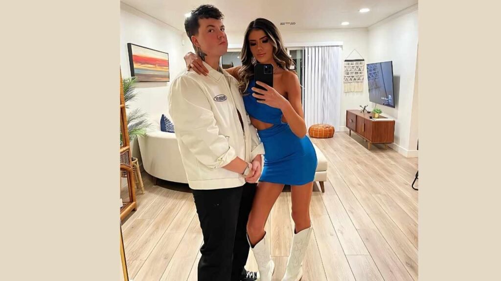 Taylor Caniff and woman in a blue dress smiling while taking a selfie together