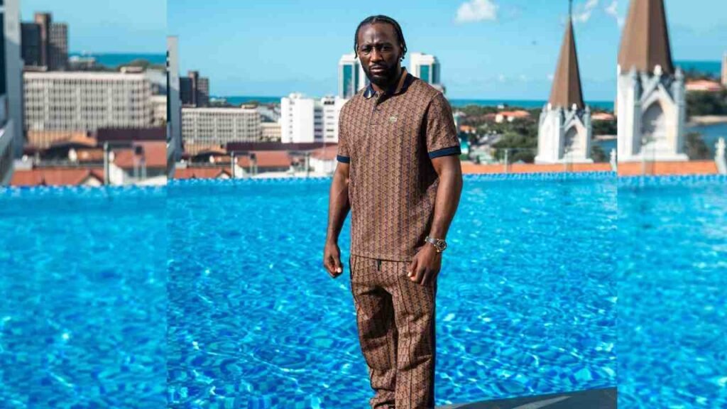 Terence Crawford stands beside a pool, with a city skyline visible in the background.