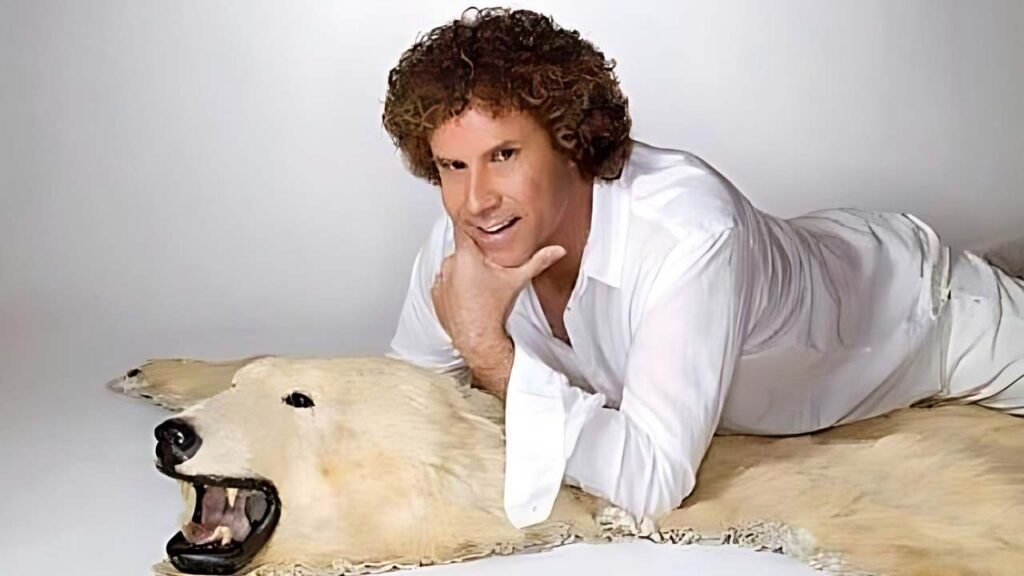 Will Ferrell reclines on a bear rug, arms crossed, with a relaxed expression on his face.