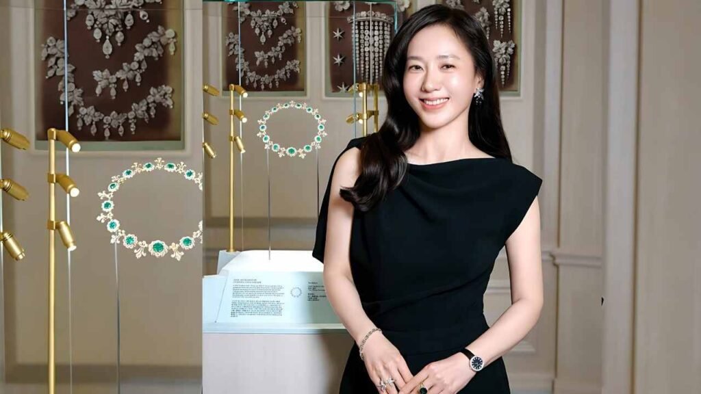 Park Joo-mi in a black dress stands beside a jewelry display, showcasing various elegant pieces.
